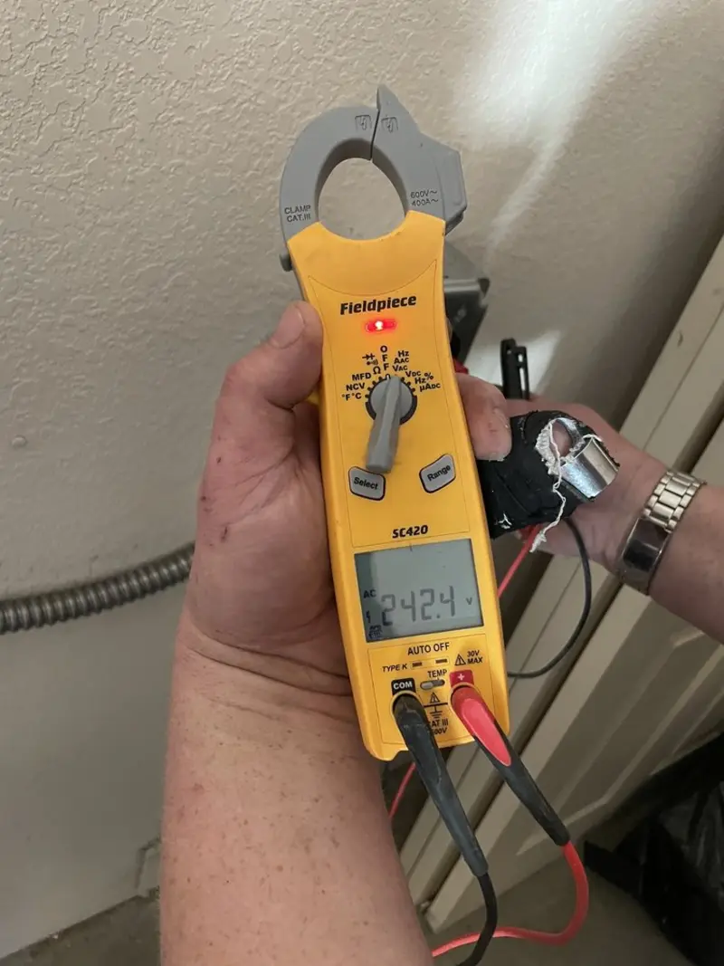 Voltage testing with clamp meter during Electrical Installation Services in Avra Valley